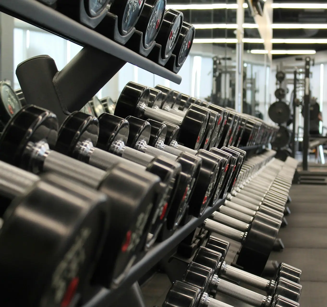 woman standing surrounded by exercise equipment